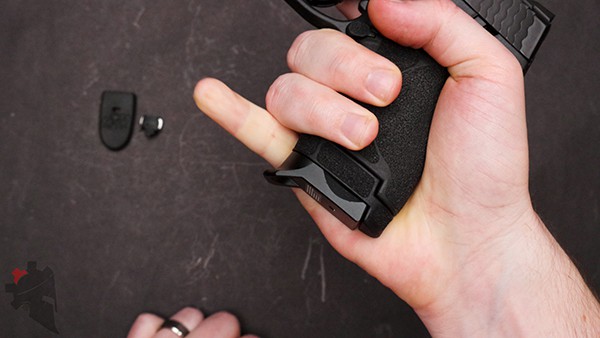 Extending pinkey to show Bastion Gear magazine baseplate extension installed on Smith and Wesson Shield